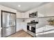 Updated kitchen with stainless steel appliances and white shaker cabinets at 80 Yvette Ne Ct, Kennesaw, GA 30144