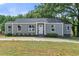 Newly renovated gray house with a white door, landscaping, and driveway at 819 Norwood Se Rd, Atlanta, GA 30315