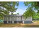 Rear view of a newly renovated gray house with a large yard at 819 Norwood Se Rd, Atlanta, GA 30315