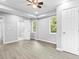 Main bedroom with gray walls, vinyl flooring, ceiling fan, and ensuite bath at 819 Norwood Se Rd, Atlanta, GA 30315