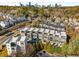 Aerial view of modern townhomes featuring rooftop decks with a city skyline in the background at 902 Lenox Ne Blvd, Atlanta, GA 30324