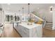 Spacious kitchen with a quartz island, stainless steel sink, and adjacent staircase at 902 Lenox Ne Blvd, Atlanta, GA 30324