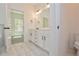 Elegant bathroom with double vanity, white cabinets, and marble-look tile at 3278 Greenhill Dr, Villa Rica, GA 30180