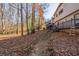 House backyard with wooden deck and walkway, surrounded by trees at 600 Green Mountain Trl, College Park, GA 30349