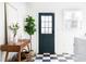 A bright laundry room with a dark green door and wood accent table at 1797 Hosea L Williams Se Dr, Atlanta, GA 30317