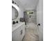 Modern bathroom with white vanity, marble tile, and a large mirror at 1841 Bayberry Dr, Atlanta, GA 30311