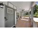 Modern front porch with gray door and wood flooring at 1841 Bayberry Dr, Atlanta, GA 30311