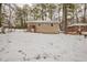 Rear view of a Ranch style home with a snow covered yard at 29 Oak Sw Dr, Atlanta, GA 30354