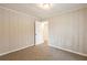 Bright bedroom with wood paneling and access to hallway at 29 Oak Sw Dr, Atlanta, GA 30354