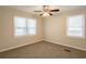 Bright bedroom with neutral walls, new carpet, and multiple windows at 29 Oak Sw Dr, Atlanta, GA 30354