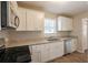 Renovated kitchen with white cabinets and granite counters at 29 Oak Sw Dr, Atlanta, GA 30354