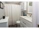 Clean bathroom with white vanity, shower, and white curtain at 399 Towler Dr, Loganville, GA 30052