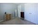 Gray bedroom with a dresser and double doors to a closet at 399 Towler Dr, Loganville, GA 30052