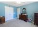 Blue bedroom with double doors leading to a closet and dresser at 399 Towler Dr, Loganville, GA 30052