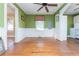 Dining area with hardwood floors, green walls, and built-in shelving at 4471 Gibson Pl, Acworth, GA 30101