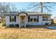 Charming bungalow with a gray exterior, striped awnings, and a yellow front door at 4471 Gibson Pl, Acworth, GA 30101