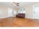 Living room with hardwood floors, a ceiling fan, and multiple doors at 4471 Gibson Pl, Acworth, GA 30101