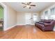 Spacious living room with hardwood floors, ceiling fan, and a burgundy leather couch at 4471 Gibson Pl, Acworth, GA 30101