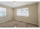 Spacious bedroom with neutral walls, carpet, and two windows at 454 Oak Se Dr, Atlanta, GA 30354