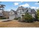 Brick two-story home with landscaping and a three-car garage at 104 Johnston Farm Ln, Woodstock, GA 30188