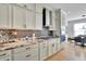 Modern kitchen with granite counters and white cabinets at 104 Johnston Farm Ln, Woodstock, GA 30188