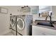 Laundry room with washer, dryer, and utility sink at 104 Johnston Farm Ln, Woodstock, GA 30188