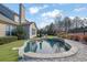 Inviting kidney-shaped pool with stone coping and landscaping at 104 Johnston Farm Ln, Woodstock, GA 30188