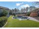 Inviting kidney-shaped pool with artificial turf at 104 Johnston Farm Ln, Woodstock, GA 30188