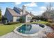 Relaxing kidney-shaped pool surrounded by landscaping at 104 Johnston Farm Ln, Woodstock, GA 30188