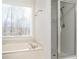 Clean bathroom with a bathtub and shower, perfect for relaxation at 2426 Woodbridge Dr, Marietta, GA 30066