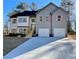 Two-story house with gray and white siding, wooden shutters, and a two-car garage at 3279 Greenhill Dr, Villa Rica, GA 30180