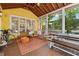 Bright yellow screened porch with seating area at 518 Hill Se St, Atlanta, GA 30312