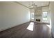 Sunlit living room with hardwood floors and stone fireplace at 5430 Crow Dr, Cumming, GA 30041