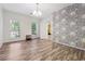 Well lit dining room with wood-look floors and large windows at 5641 Roswell Rd # 103, Atlanta, GA 30342
