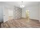 Spacious dining room with wood-look floors and accent wall at 5641 Roswell Rd # 103, Atlanta, GA 30342