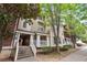 Brick and tan three-story building with trees and a sidewalk at 5641 Roswell Rd # 103, Atlanta, GA 30342