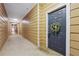 Building hallway with tan walls and a dark blue door at 5641 Roswell Rd # 103, Atlanta, GA 30342