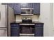 Modern kitchen features stainless steel appliances and dark blue cabinetry at 5641 Roswell Rd # 103, Atlanta, GA 30342