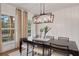 Elegant dining room with chandelier, large window, and wood table at 6075 Marigold Way, Atlanta, GA 30349