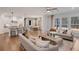 Open concept kitchen and living space with an island and hardwood floors at 6075 Marigold Way, Atlanta, GA 30349