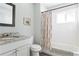 Bathroom with shower/tub combo, tile, and updated vanity at 1618 Athens Sw Ave, Atlanta, GA 30310