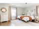 Bright bedroom with hardwood floors, large window, and cozy bedding at 1618 Athens Sw Ave, Atlanta, GA 30310