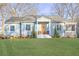 Charming ranch home with light blue siding, white trim, and a landscaped lawn at 1618 Athens Sw Ave, Atlanta, GA 30310