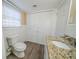 Updated bathroom with granite vanity and white tiled walls at 2725 Rainbow Forest Dr, Decatur, GA 30034