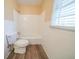 Clean bathroom with a shower/tub combo and wood-look flooring at 2725 Rainbow Forest Dr, Decatur, GA 30034