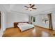 Spacious main bedroom with hardwood floors, ceiling fan, and large windows at 60 Old Fuller Mill Ne Rd, Marietta, GA 30067