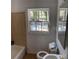 Small bathroom with tan tile and a window at 678 Charlotte Nw Pl, Atlanta, GA 30318