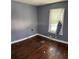 Gray walls and hardwood floors in this empty bedroom at 678 Charlotte Nw Pl, Atlanta, GA 30318