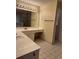 Bright bathroom with double sink vanity, tiled floor, and shower stall at 143 Tracy Ln, Mcdonough, GA 30253