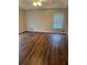 This primary bedroom is spacious, with wood floors and plenty of natural light at 143 Tracy Ln, Mcdonough, GA 30253